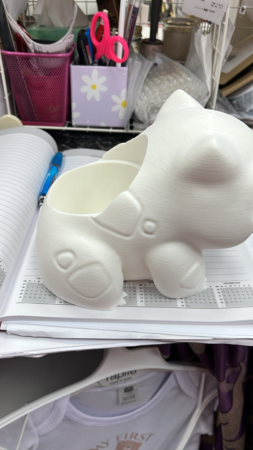 White 3D printed bulb creature figure showing hollow back compartment